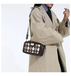 Close-up of retro argyle pattern shoulder bag with a stylish wide geometric strap