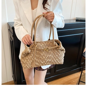 Detail of light brown faux shearling handbag with slim leather handles and soft texture