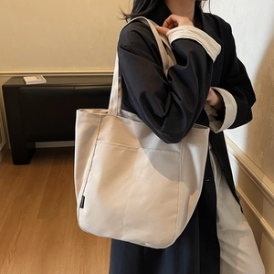 Minimalist beige canvas tote bag with side pockets and large capacity for women