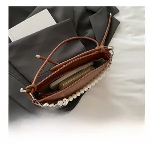 Interior view of brown saddle bag showing capacity for phone and long wallet