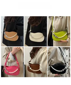 Six assorted candy-colored underarm bags featuring pearl heart chains on a grid