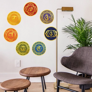Detail view of seven colorful chakra yoga wall stickers arranged in a modern living room