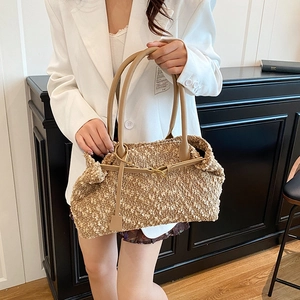 Brown textured faux shearling shoulder bag with leather handles and metallic buckle detail