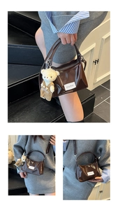 Close-up of dark brown patent leather handbag featuring a cute plush bear pendant accessory