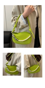 Detail of neon green glossy shoulder bag with pearl heart chain and curved top design