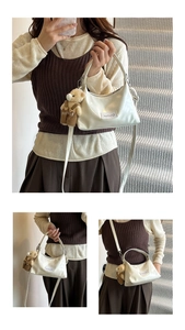 Chic cream white patent leather handbag with plush bear charm and crossbody strap details