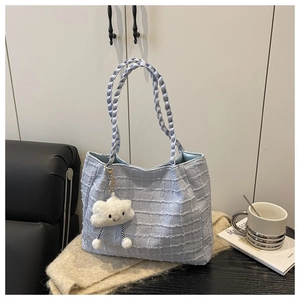 Light blue textured tote bag with woven handles and a cute cloud plush charm