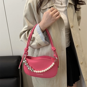 Vibrant pink faux leather underarm bag with pearl heart chain and knot strap detail
