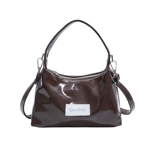Glossy dark brown patent leather handbag with top handle and Qiyllur label design