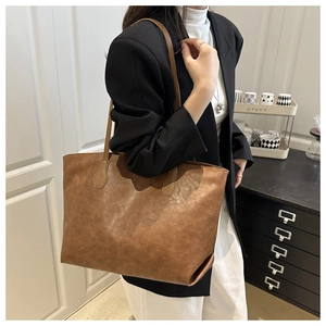 Brown vintage faux leather tote bag showcased in a minimalist home interior setting