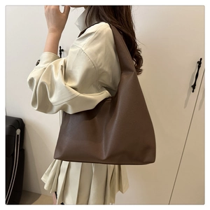 Deep brown lychee texture tote bag on model showing elegant drape and large capacity