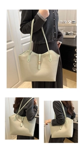 Macro detail of mint green tote bag showing lychee grain leather and gold metal buckle