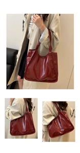 Detail of burgundy patent leather tote bag showing glossy finish and spacious shoulder design