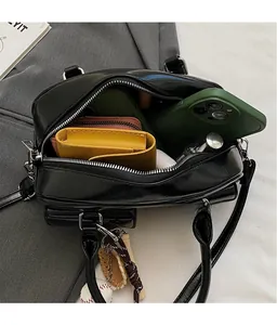 Interior view showing the large capacity of this black patent leather bag for daily essentials