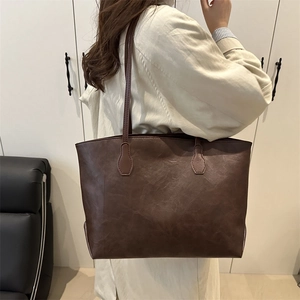 Retro deep brown leather tote bag for women showing a spacious interior for daily commute
