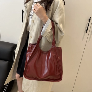 Minimalist large dark red patent leather tote bag for women in a casual commuter style