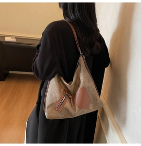 Detail of vintage matte tote bag with leather straps on model's shoulder for daily use
