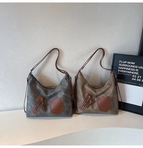 Detail of large canvas tote bags with leather straps and front zipper pockets for women