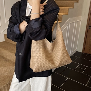 Large khaki woven shoulder tote bag with minimalist retro bucket shape for daily commute