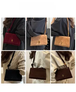Detail showing high-quality suede clutch bags with gold metal clasps in four colors