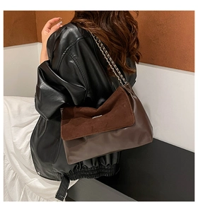 Detail of vintage contrast chain shoulder bag with brown leather and suede texture
