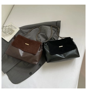 Close-up of retro chain tote bags in brown and black with matte flap and metal buckle
