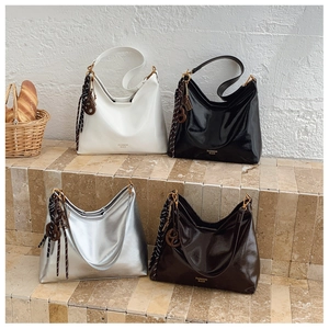 Close-up of minimalist leather tote bags in four colors on stone stairs for daily commute