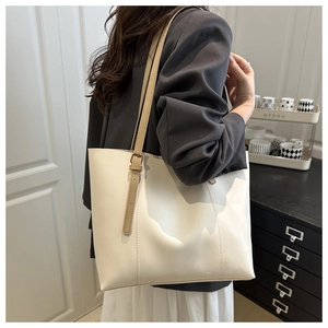 Detail of cream tote bag with khaki shoulder strap and fashion text engraving