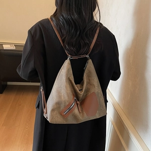 Large vintage brown tote bag with zipper detail, styled on model for commute fashion