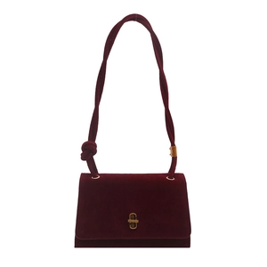Elegant burgundy velvet shoulder bag with a vintage gold twist lock on white background