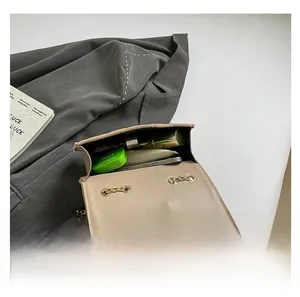 Top view of compact crossbody bag interior showing storage for phone and cosmetics
