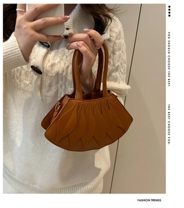 Detail shot of brown shoulder bag featuring unique layered petal-shaped leather structure