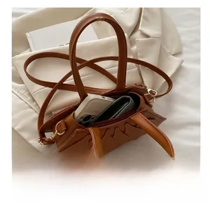 Internal view of brown leather fan bag showing capacity for phone and wallet