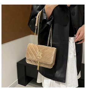 Detailed close-up of champagne velvet crossbody bag with quilted texture and metal SS logo