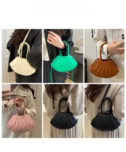 Collage of pleated leaf-shaped handbags in five colors with round top handles and straps