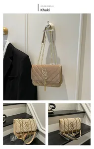 Detail of khaki velvet bag with V-quilted pattern, S-buckle and golden chain strap