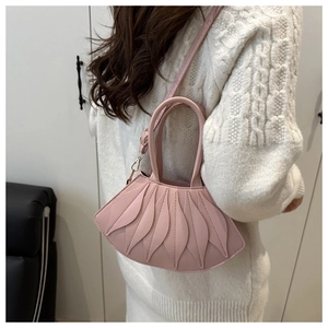 Side view of a light pink fan-shaped shoulder bag with petal-like pleated details