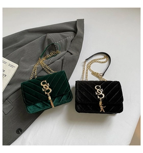 Detail view of velvet flap bags with V-shaped quilting, SS buckle, and tassel charms