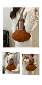 Detail of caramel fan-shaped shoulder bag with quilted leaf texture and gold buckle