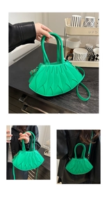 Detailed view of layered fan-shaped pleats on bright green PU leather shoulder bag