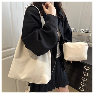 Minimalist beige tote bag set with matching small zipper pouch and wide shoulder straps
