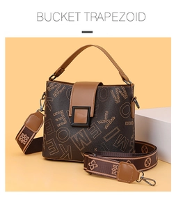 Close-up of the letter print pattern and square buckle on this brown bucket bag