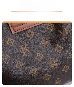 Close-up of vintage monogram pattern on high-quality pebbled leather bucket bag