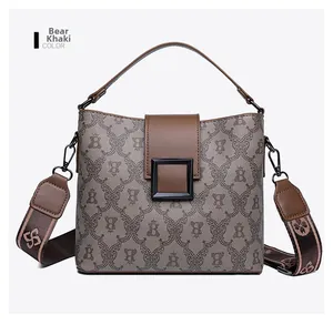 Detail of Bear Khaki bucket bag with vintage monogram patterns and stylish square lock