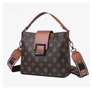 Detail of vintage monogram bucket bag with letter K print and matte black metal buckle