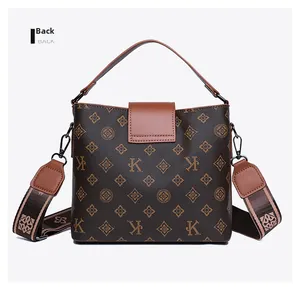 Detailed back view of vintage monogram bucket bag with caramel leather straps and wide strap