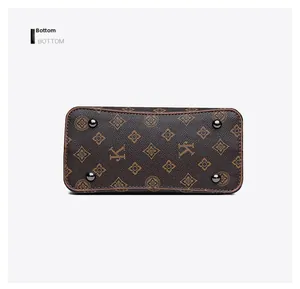 Detail view of the handbag bottom featuring vintage monogram pattern and protective metal feet