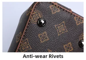 Detailed macro view of protective anti-wear rivets on the vintage leather bucket bag base