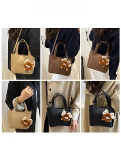 Litchi pattern leather bucket bag details with plush monster charm and adjustable strap