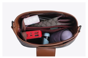 Top-down view showing large capacity interior with zipper compartment and red lining